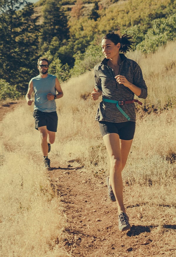 Man and Woman running on trail